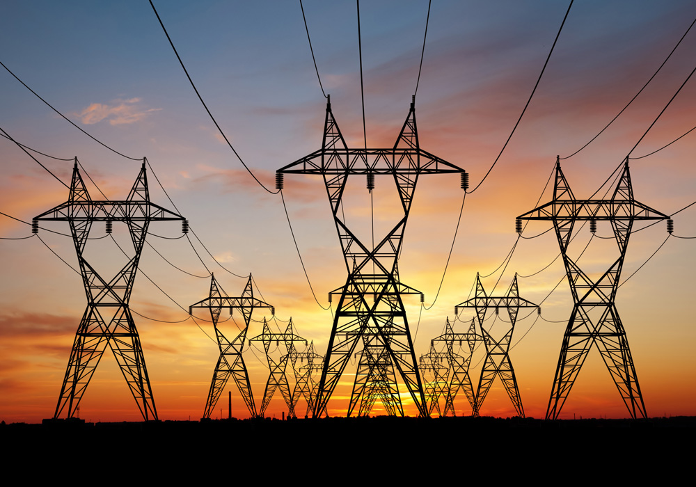 Utility-scale transmission lines at sunset