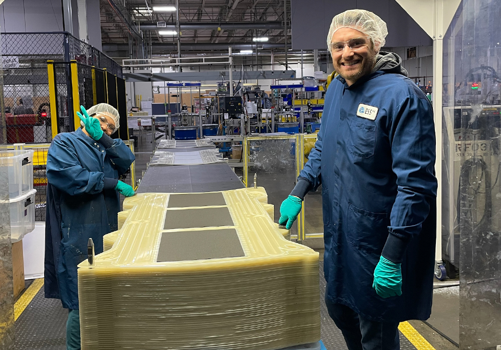 Two employees on the ess inc. Factory floor image