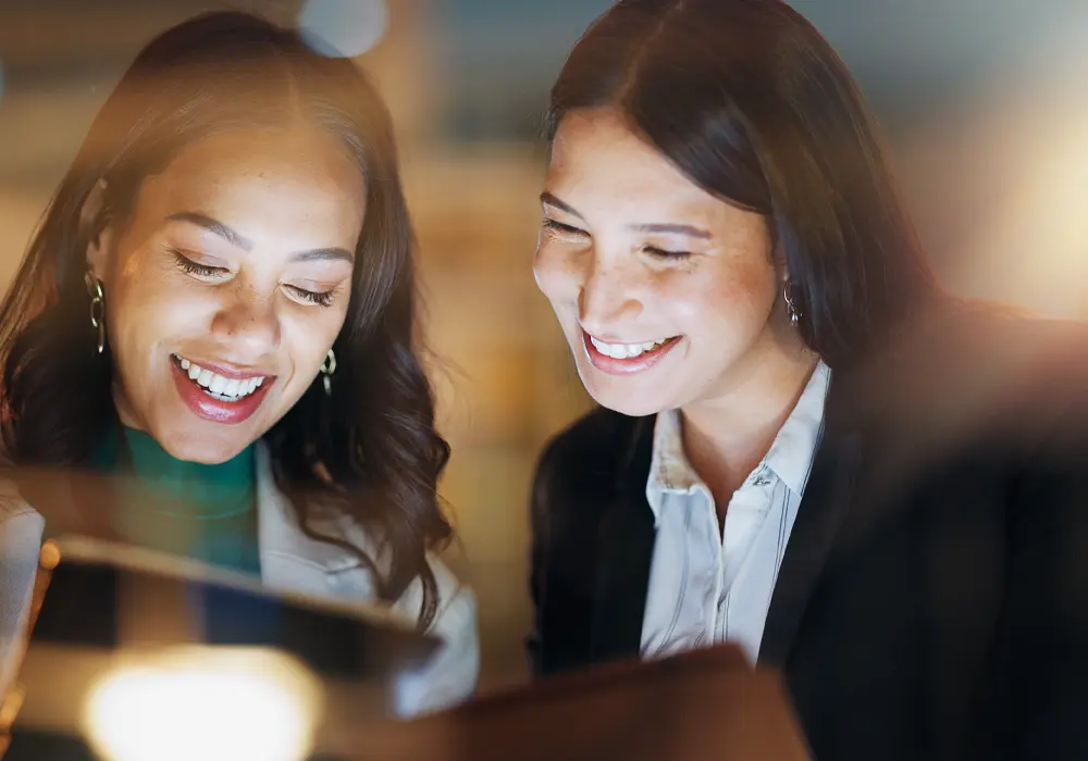 Two office workers working into the evening